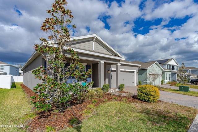 view of front of home with a garage and a front lawn