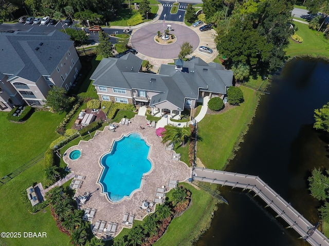 view of property location with a pool and a nearby body of water