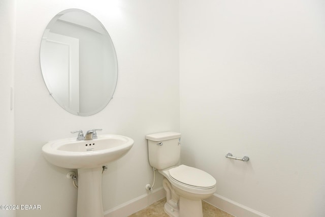 bathroom with tile patterned flooring and toilet