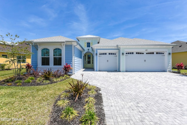 view of front of home featuring a front lawn and a garage