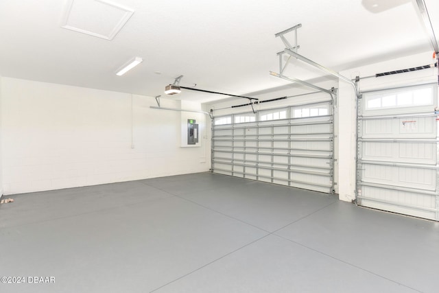 garage with electric panel and a garage door opener