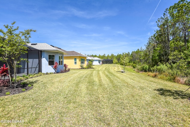 view of yard with a lanai