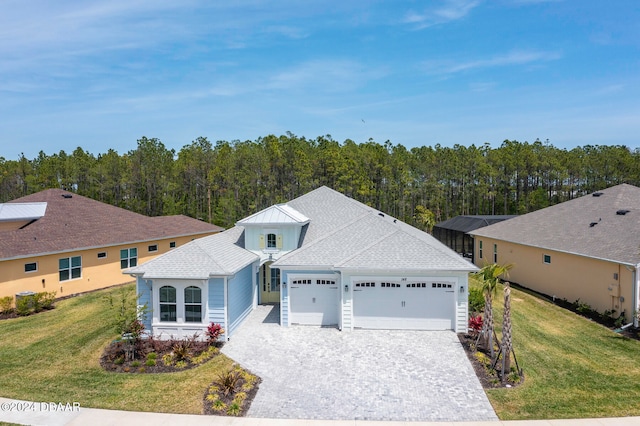 view of front of property with a front lawn and a garage