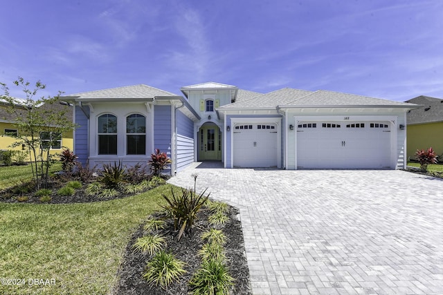 148 Six String Dr, Daytona Beach, FL 32124 - view of front of house with an attached garage, driveway, and a front yard