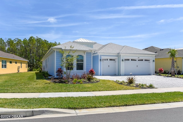 ranch-style house featuring a front lawn and a garage