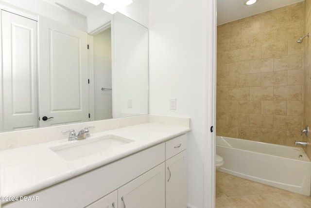 full bathroom with tile patterned floors, vanity, tiled shower / bath combo, and toilet