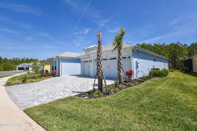 view of side of property featuring a yard and a garage