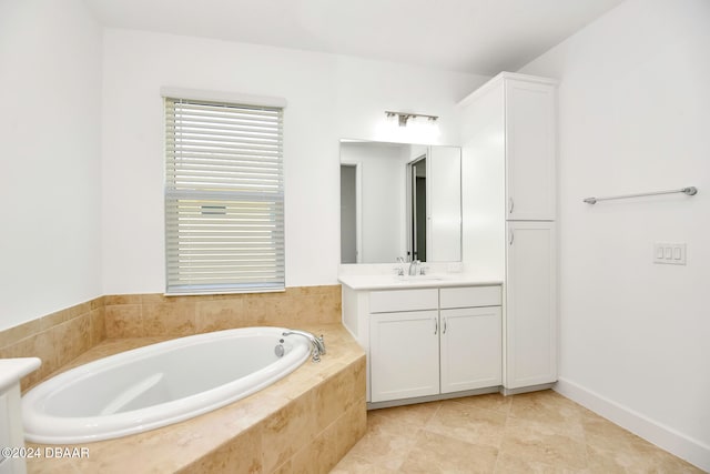 bathroom featuring vanity, tiled bath, and tile patterned floors