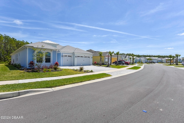 single story home featuring a front yard and a garage