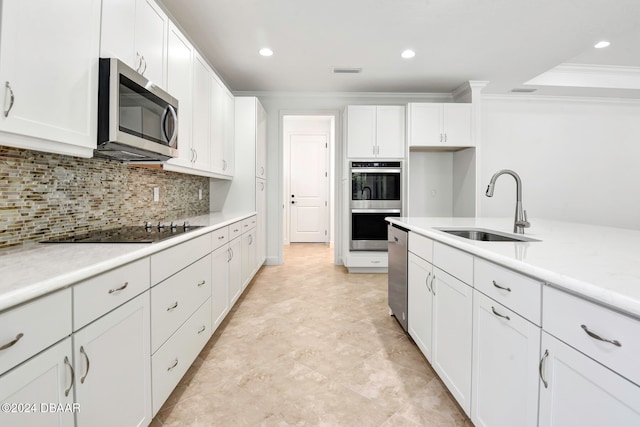 kitchen featuring tasteful backsplash, ornamental molding, stainless steel appliances, sink, and white cabinets