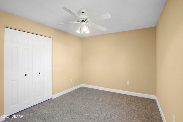 unfurnished bedroom featuring carpet flooring, ceiling fan, and a closet