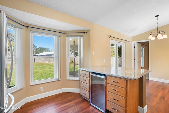 kitchen featuring wine cooler, plenty of natural light, pendant lighting, and dark hardwood / wood-style flooring