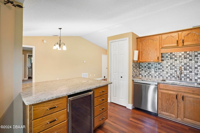 kitchen with dishwasher, dark wood-type flooring, beverage cooler, lofted ceiling, and decorative light fixtures