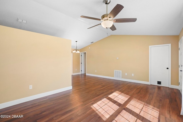 unfurnished living room featuring ceiling fan with notable chandelier, dark wood-type flooring, and vaulted ceiling