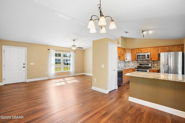 kitchen featuring appliances with stainless steel finishes, ceiling fan with notable chandelier, hanging light fixtures, and dark wood-type flooring