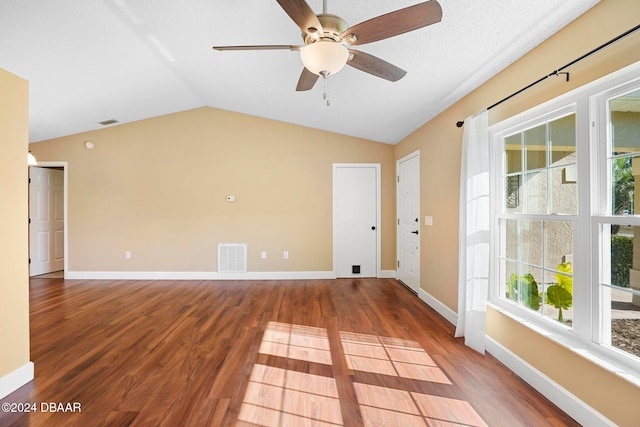 spare room featuring lofted ceiling, ceiling fan, and wood-type flooring