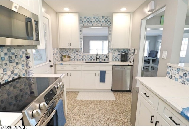 kitchen featuring appliances with stainless steel finishes, sink, and white cabinets