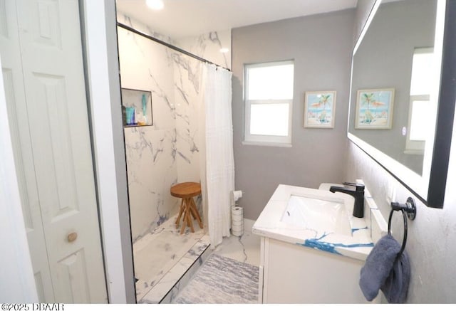 bathroom featuring vanity and curtained shower