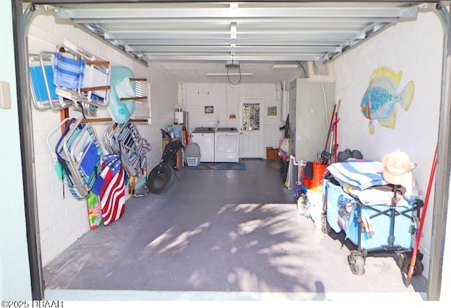 garage with washer and clothes dryer