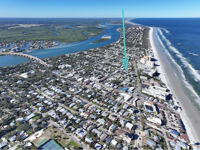 drone / aerial view with a water view and a view of the beach