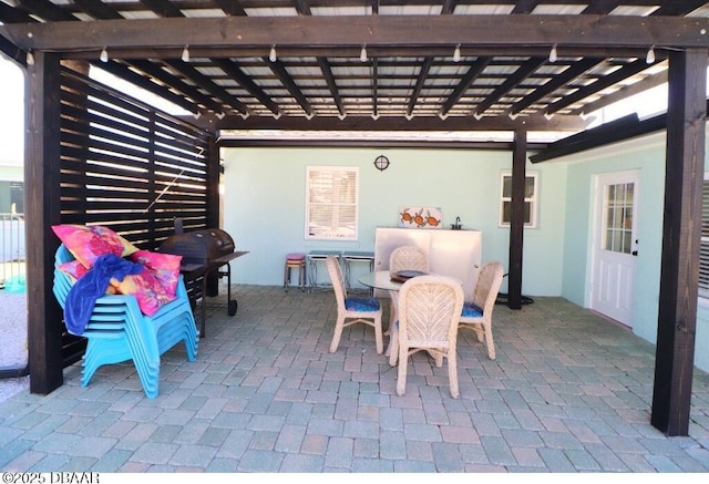 view of patio featuring a grill and a pergola