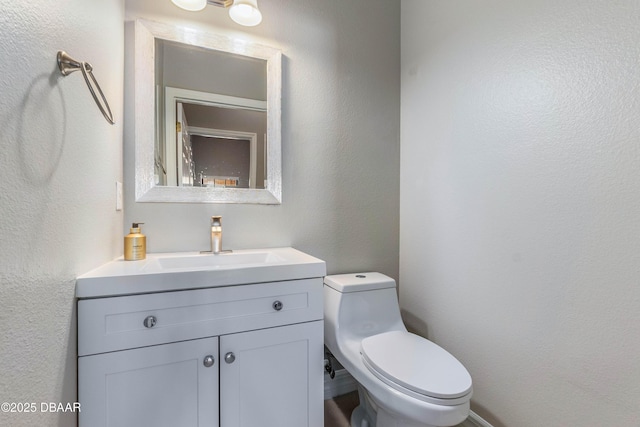 bathroom with toilet and vanity