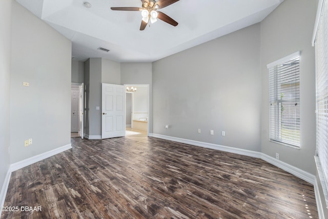 unfurnished bedroom with dark hardwood / wood-style flooring and ceiling fan with notable chandelier