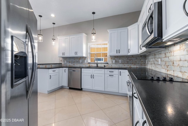 kitchen with light tile patterned floors, sink, decorative light fixtures, stainless steel appliances, and white cabinets