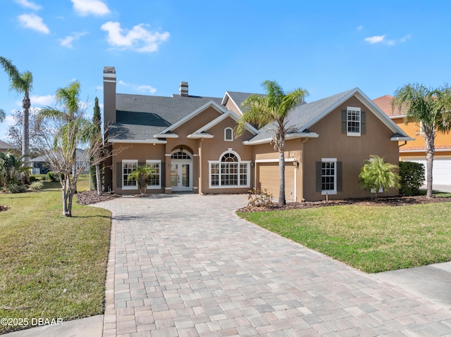 view of front facade with a front lawn and a garage