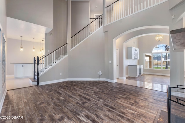 interior space featuring wood-type flooring and a high ceiling