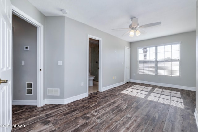 spare room with ceiling fan and dark wood-type flooring