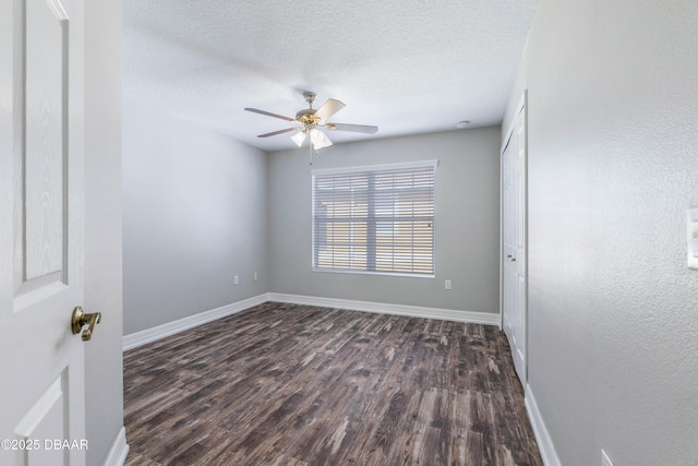 unfurnished room with a textured ceiling, ceiling fan, and dark hardwood / wood-style floors