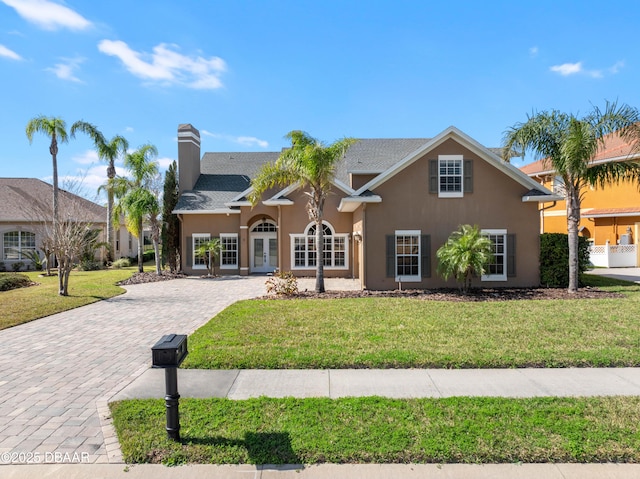 view of front of home featuring french doors and a front lawn