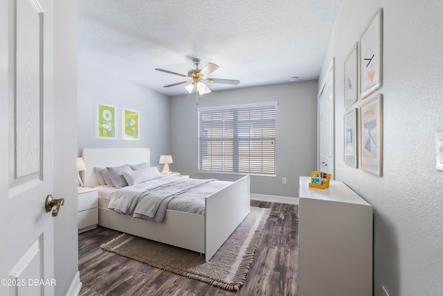 bedroom featuring a textured ceiling, dark hardwood / wood-style floors, and ceiling fan