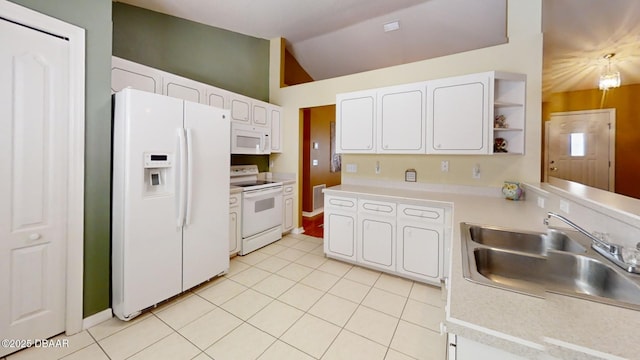 kitchen featuring light tile patterned floors, white cabinets, vaulted ceiling, a sink, and white appliances