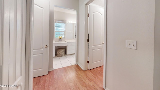 hallway with light wood-style floors