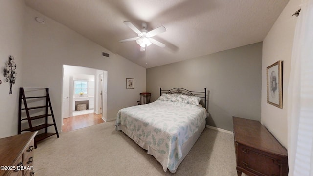 bedroom featuring light carpet, visible vents, connected bathroom, a ceiling fan, and lofted ceiling