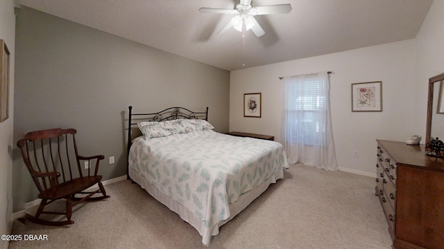 bedroom featuring baseboards, a ceiling fan, and light colored carpet