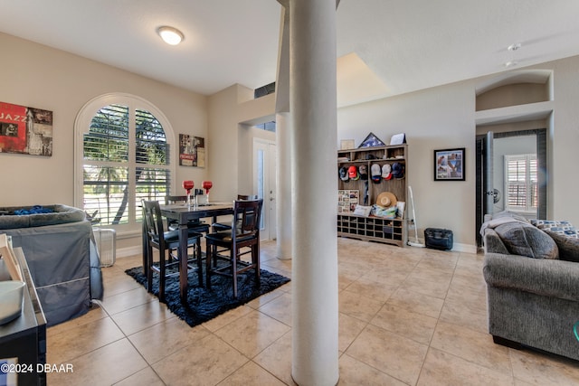 dining space with ornate columns and light tile patterned floors