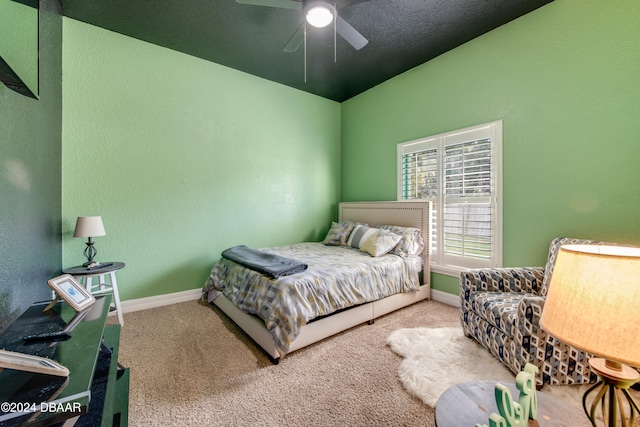 carpeted bedroom with a textured ceiling and ceiling fan