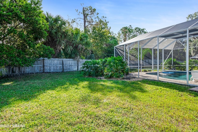 view of yard featuring a lanai and a fenced in pool