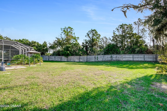 view of yard featuring a lanai