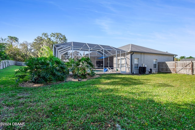 view of yard with a lanai and central AC