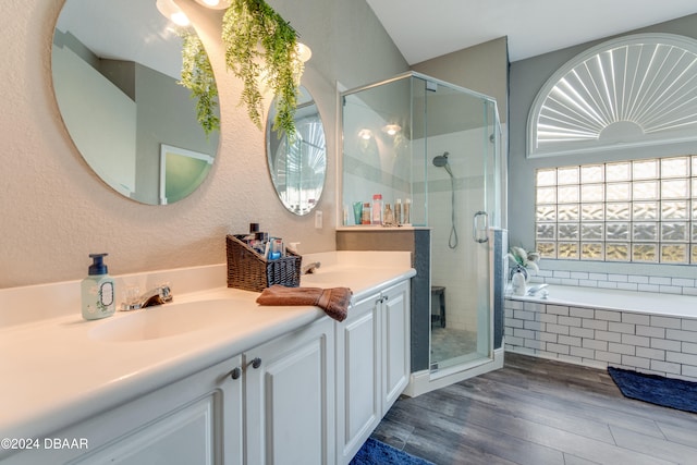 bathroom featuring hardwood / wood-style floors, vanity, and shower with separate bathtub