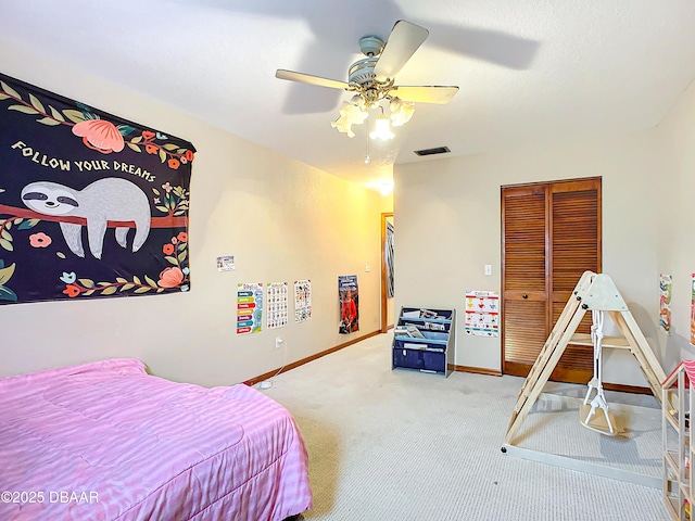 bedroom featuring ceiling fan, carpet, and a closet