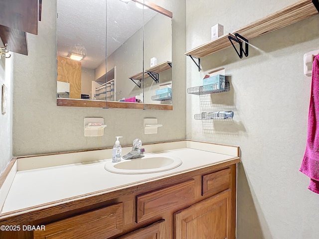 bathroom featuring vanity and a textured ceiling