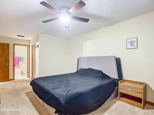 bedroom featuring ensuite bath and ceiling fan