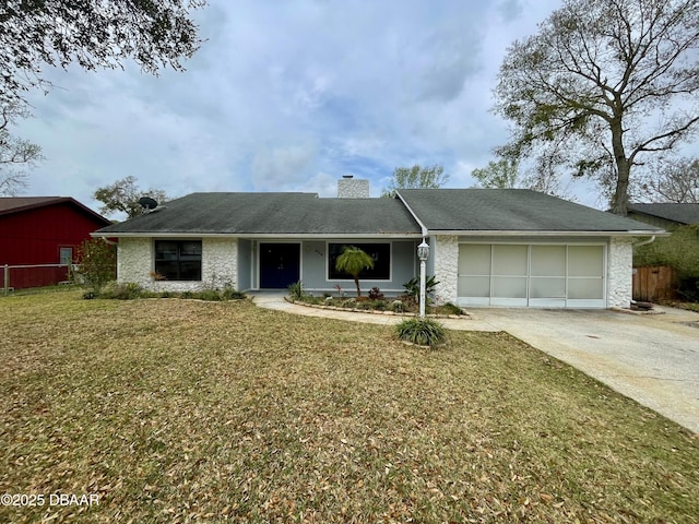 ranch-style house with a garage, concrete driveway, a chimney, fence, and a front lawn