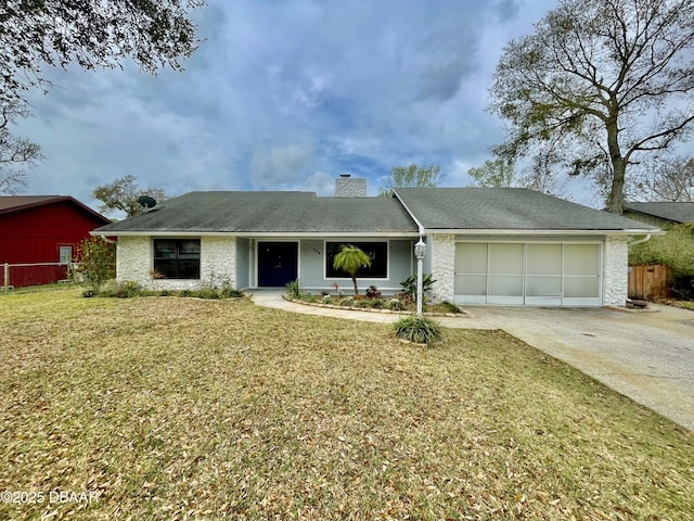 single story home featuring a garage, fence, concrete driveway, a front lawn, and a chimney