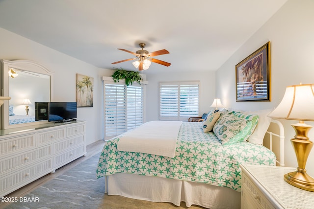 bedroom featuring hardwood / wood-style flooring and ceiling fan